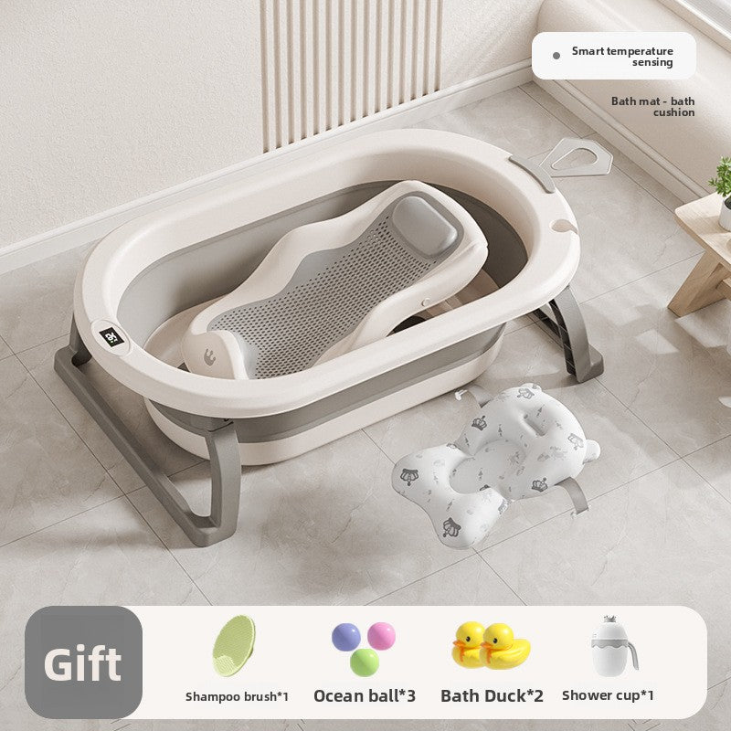 Baby bathtub with mesh bath rack and a printed floating bath mat beside it on a tiled floor