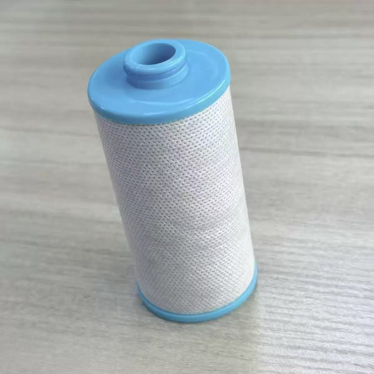 Option KDF filter cartridge: cylindrical cartridge with a mesh covered body and blue end caps on a grey surface