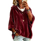 Relaxed womens hooded top with a soft sheen and dropped shoulders indoors