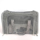 Grey pet carrier photographed head on showing the full mesh front panel and twin webbing handles