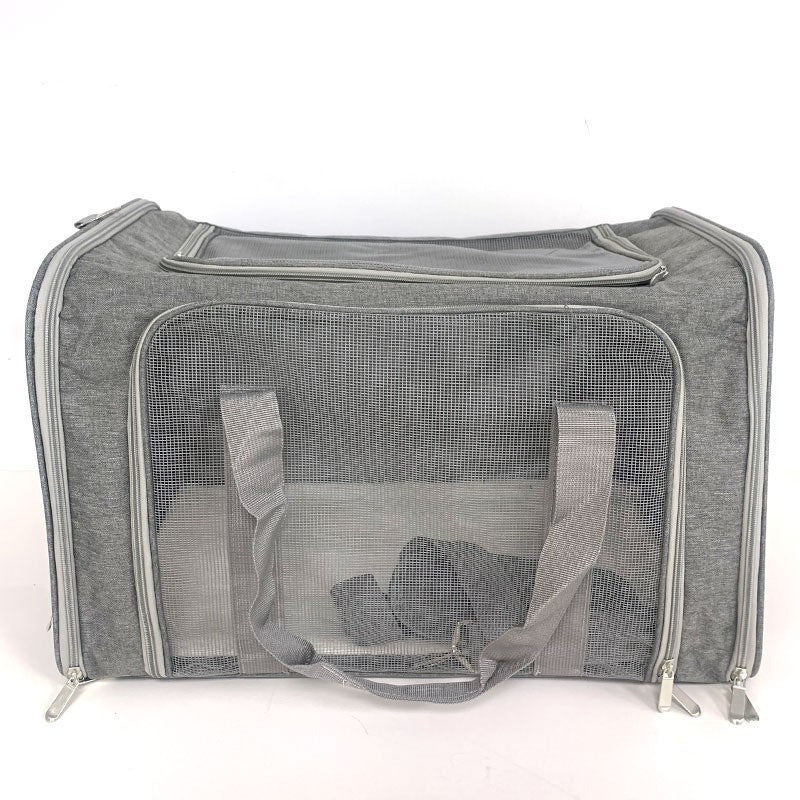 Grey pet carrier photographed head on showing the full mesh front panel and twin webbing handles