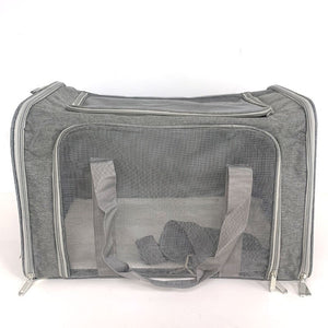 Grey pet carrier photographed head on showing the full mesh front panel and twin webbing handles