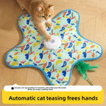 Ginger cat pawing the white motor puck on a printed star shaped cat teaser mat on a wooden floor