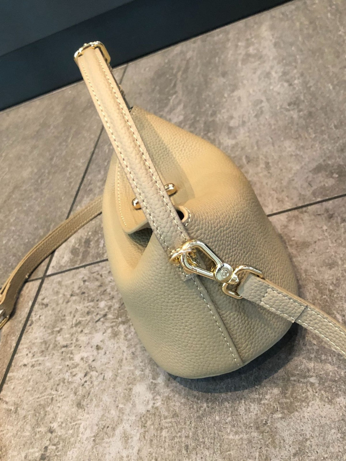 Genuine cowhide crossbody bag in black side profile