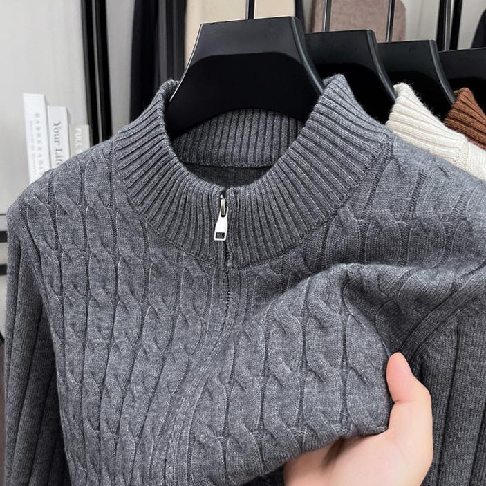 Gray thick cable knit half zip sweater with a stand collar and neck zip
