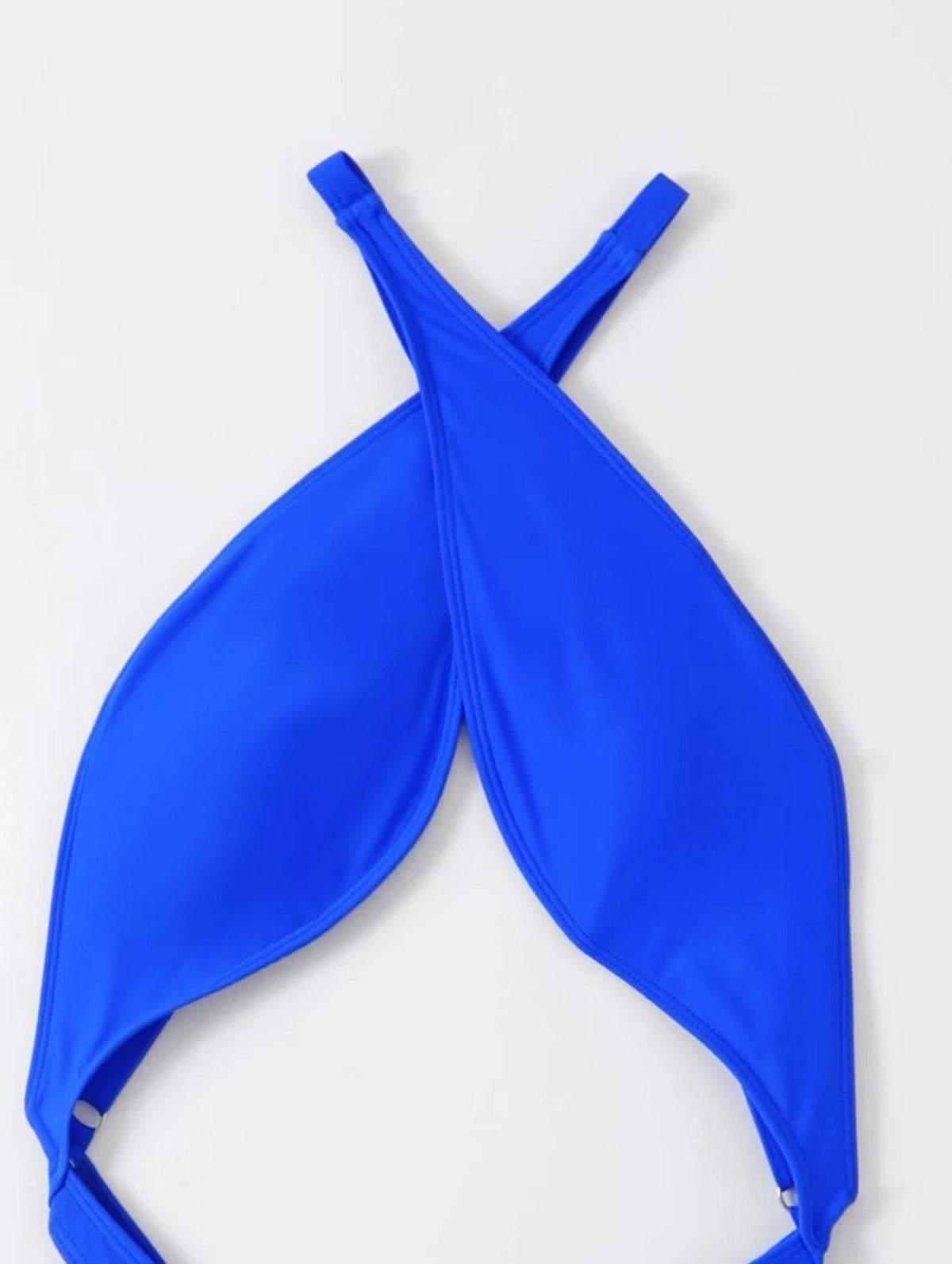 Close view of the crossover shoulder straps on the blue one piece swimsuit