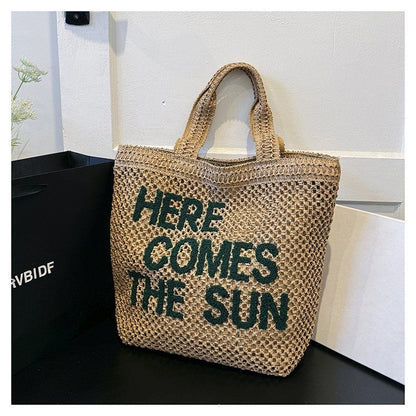 Studio shot of the embroidered woven cotton shoulder bag and its strap