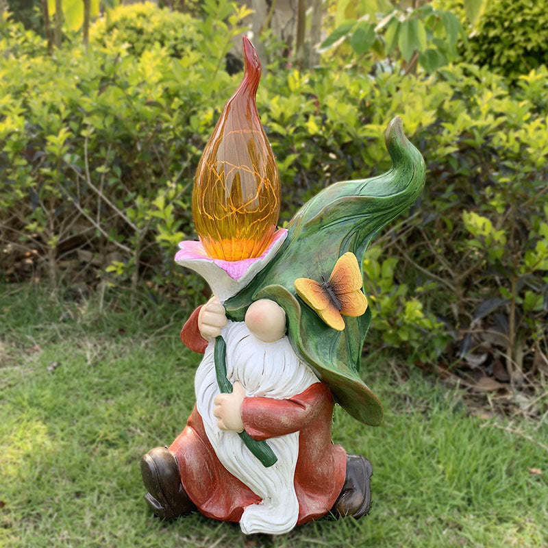 Gnome in red robe holding a glowing amber flame lamp on grass, Lighting Wizard option