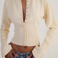 Grey rib knit cardigan buttoned to the hem showing the slim French style line