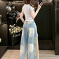 Frayed star applique detail on the front of light washed blue wide leg denim baggy jeans