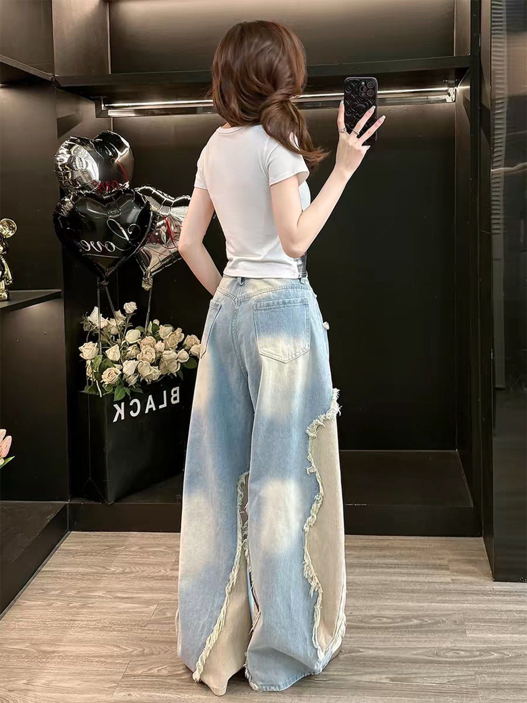 Frayed star applique detail on the front of light washed blue wide leg denim baggy jeans