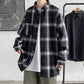 Black plaid oversized long sleeve shirt worn open, front styling view