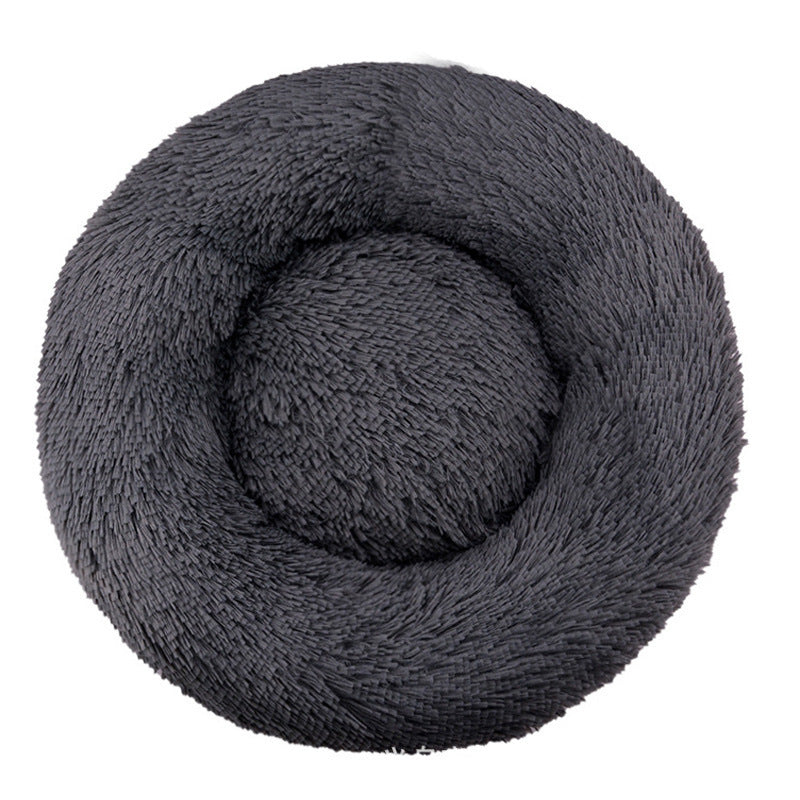 Dark gray round plush pet bed with a raised bolster rim on a plain background