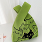 Knitted pattern wrist bag with a soft unstructured body and open top