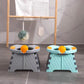 Gray and mint folding kids potties with orange splash pee shields open on a bathroom floor