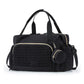 Black nylon diaper bag tote with gold tone zips, braided quilt panel and a clip on round pacifier pouch