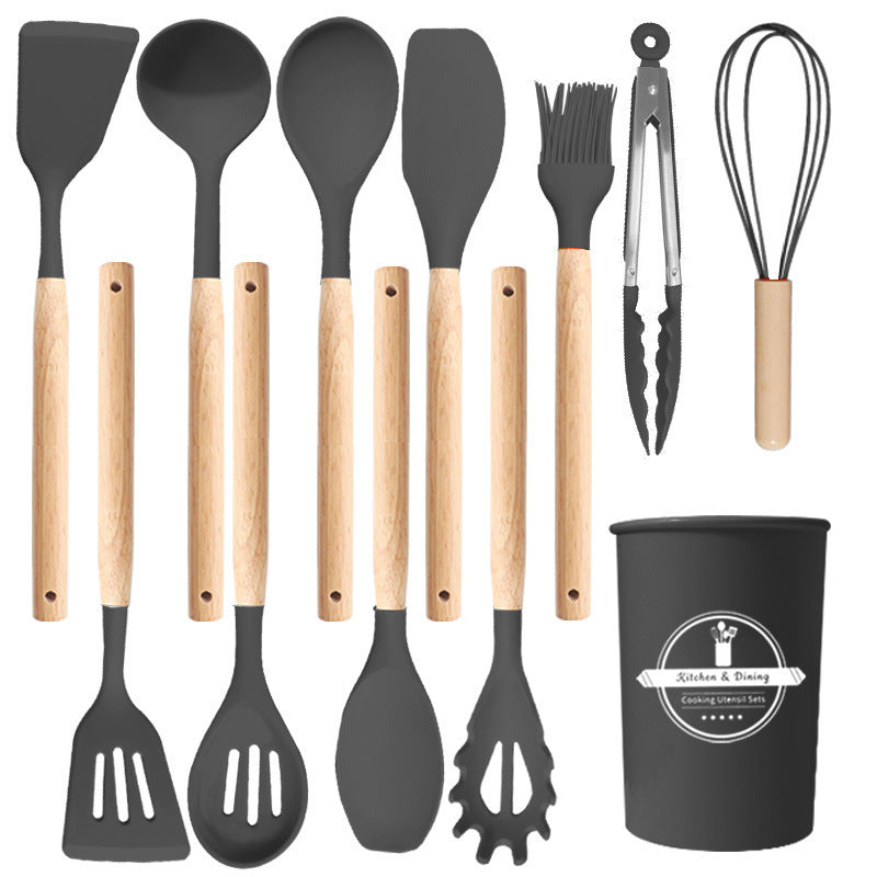 Dark gray kitchen utensil set shown flat with all twelve pieces and the matching holder
