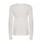 Back view of a white long sleeve babydoll top with a gathered waist seam and deep cuffs on a plain background