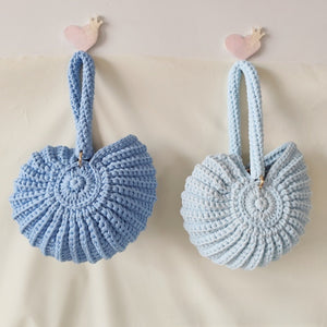 Handmade Woven Conch Shell Coin Purse | side profile angle shot