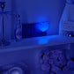 Blue heart night light glowing on a shelf in a dark blue lit room