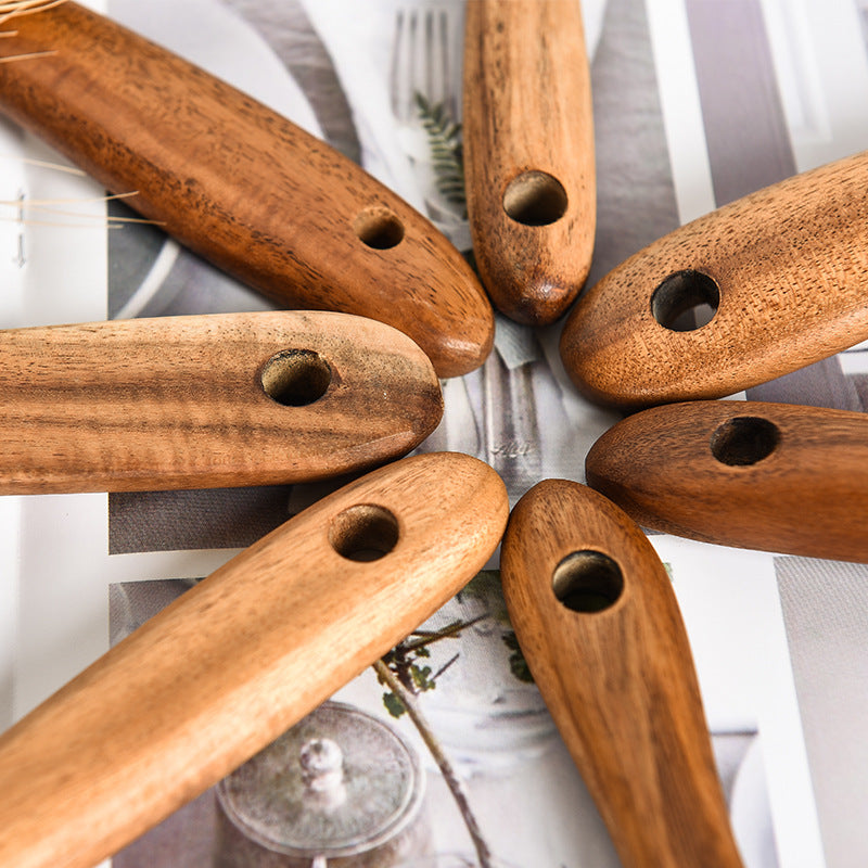 Teak colander showing drainage slots in the head