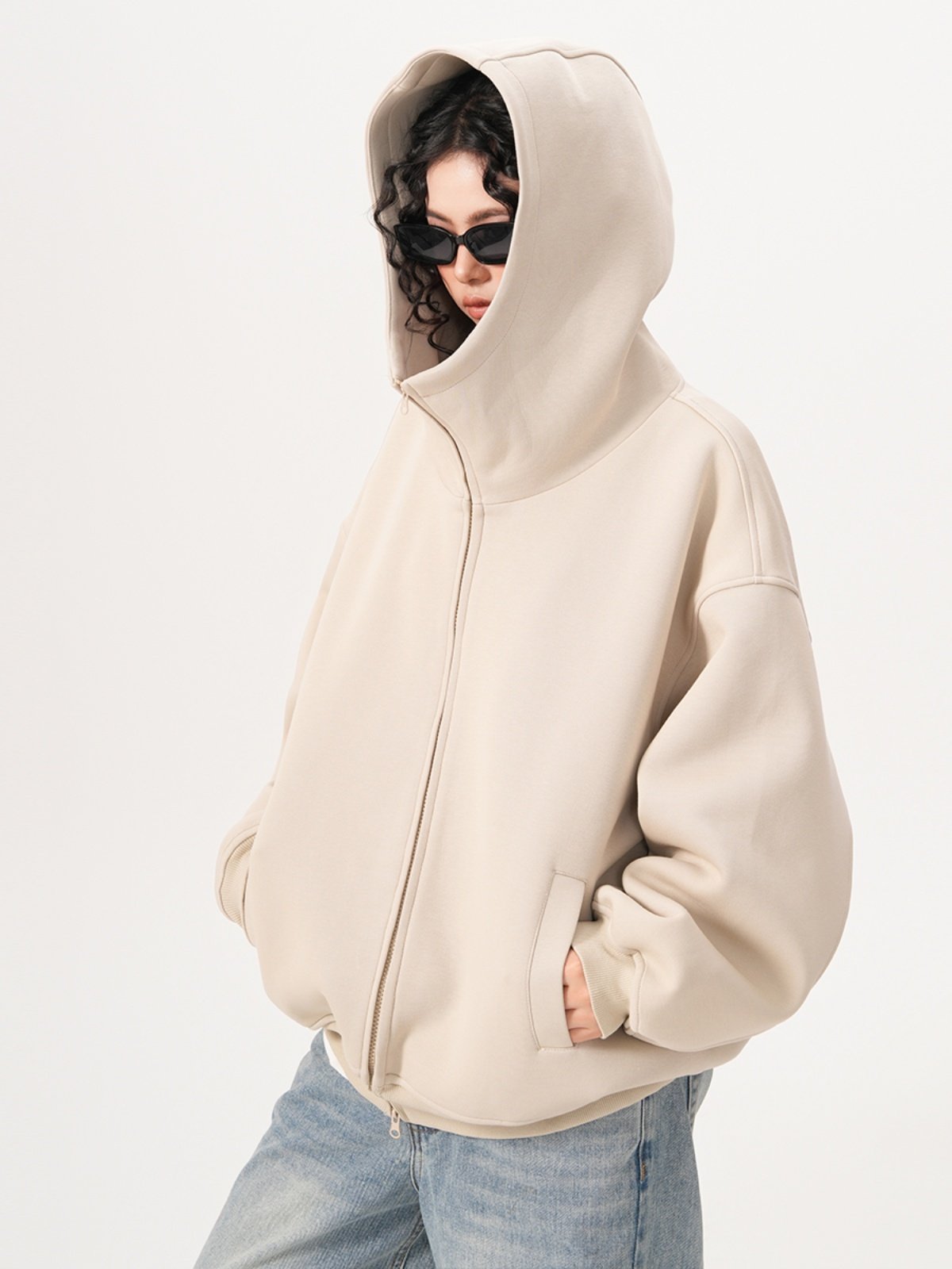 Side view of the air layer knit zip hoodie with dropped shoulders and roomy sleeves