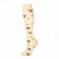 Cream knee-high compression sock with small pink blossoms and a pale yellow heel, size L/XL, on a white background