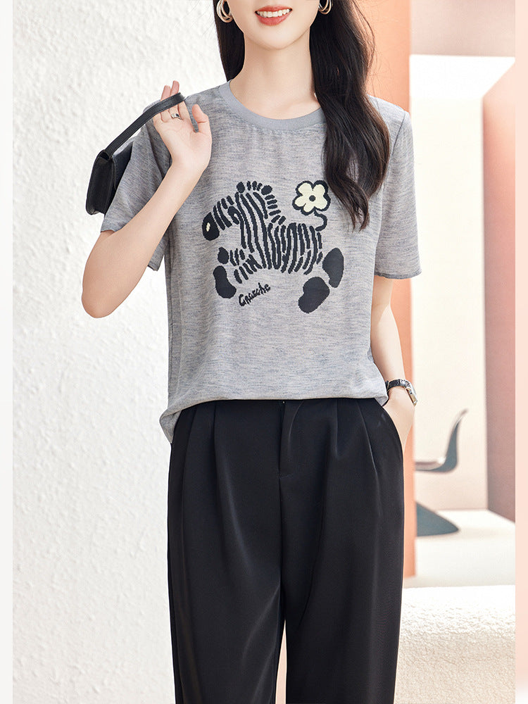 Glacier Gray short sleeve silk blouse with zebra motif styled with black trousers