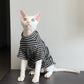 Black and white striped cat shirt on a seated hairless cat looking up, front view, black option photo
