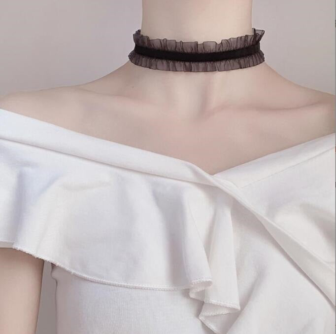 Vintage lace choker necklace displayed on a neck form against a plain backdrop