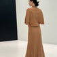 Back view of a caramel long ribbed knit skirt with flared hem styled with a knit top, top not included