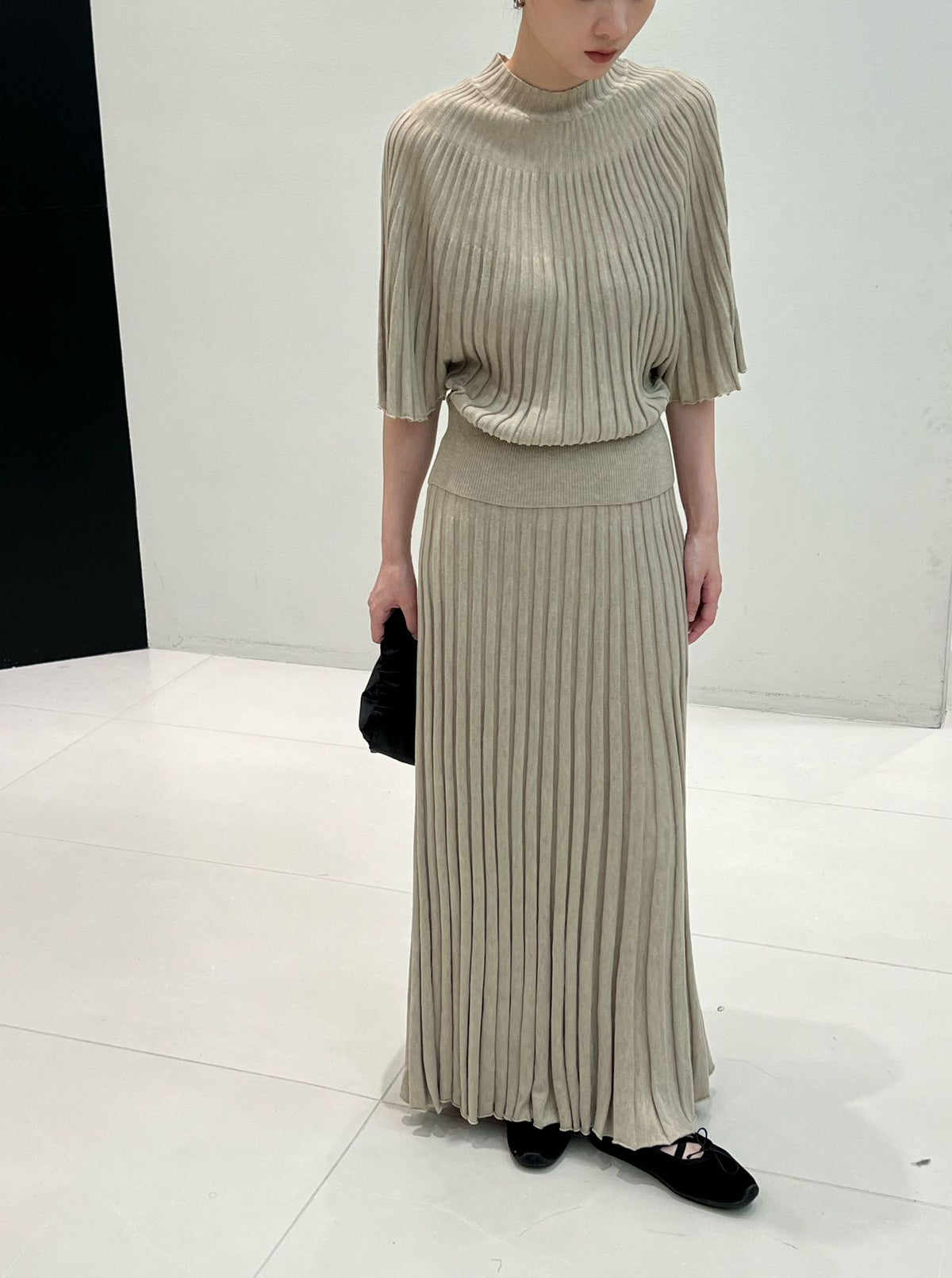 Greige long ribbed knit skirt with flat waistband styled with a knit top, top not included