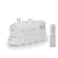 White steam locomotive shaped ultrasonic humidifier with a white wireless remote control beside it