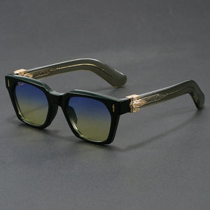 Green square framed sunglasses with wide temples and a gold arrowhead detail on a grey backdrop