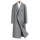 Gray double breasted long wool blend coat on a wooden hanger over a white roll neck, front view