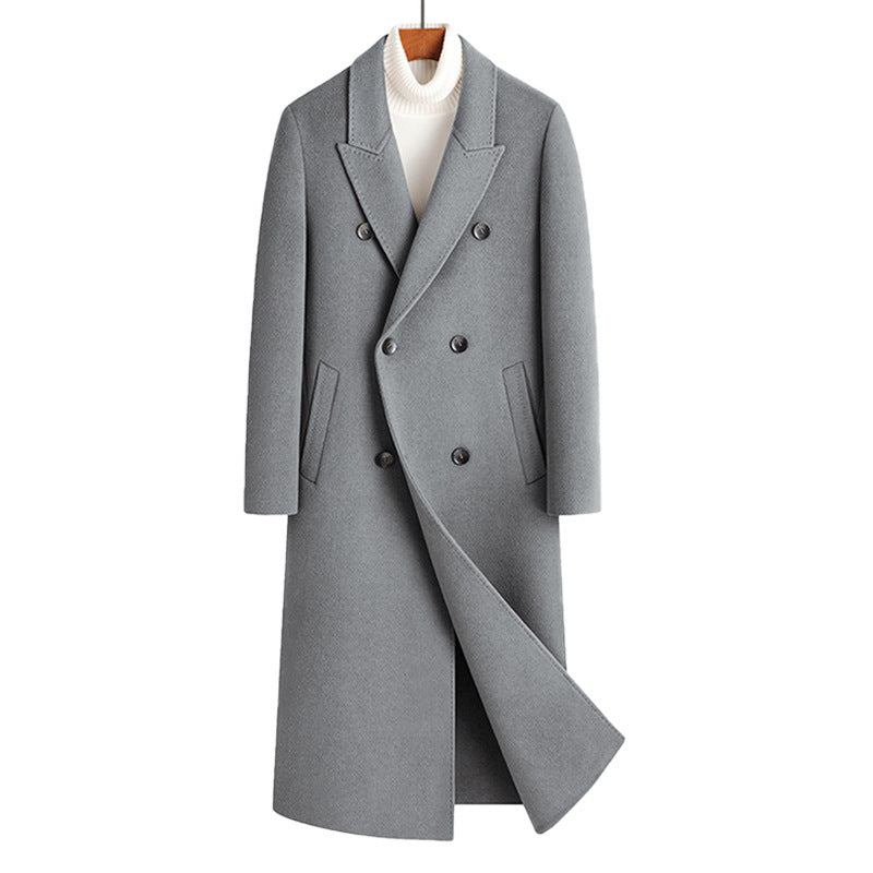 Gray double breasted long wool blend coat on a wooden hanger over a white roll neck, front view