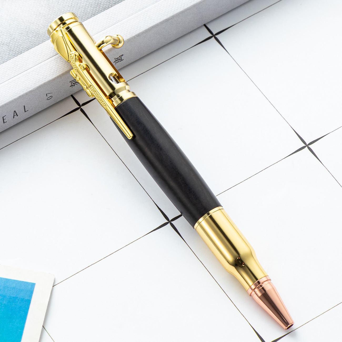 Wood barrel bolt action ballpoint pen with rifle style metal bolt lever and bullet nose