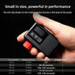 Hand holding the black electric air pump showing the red knob, three buttons and LED display, with a tire inflation table