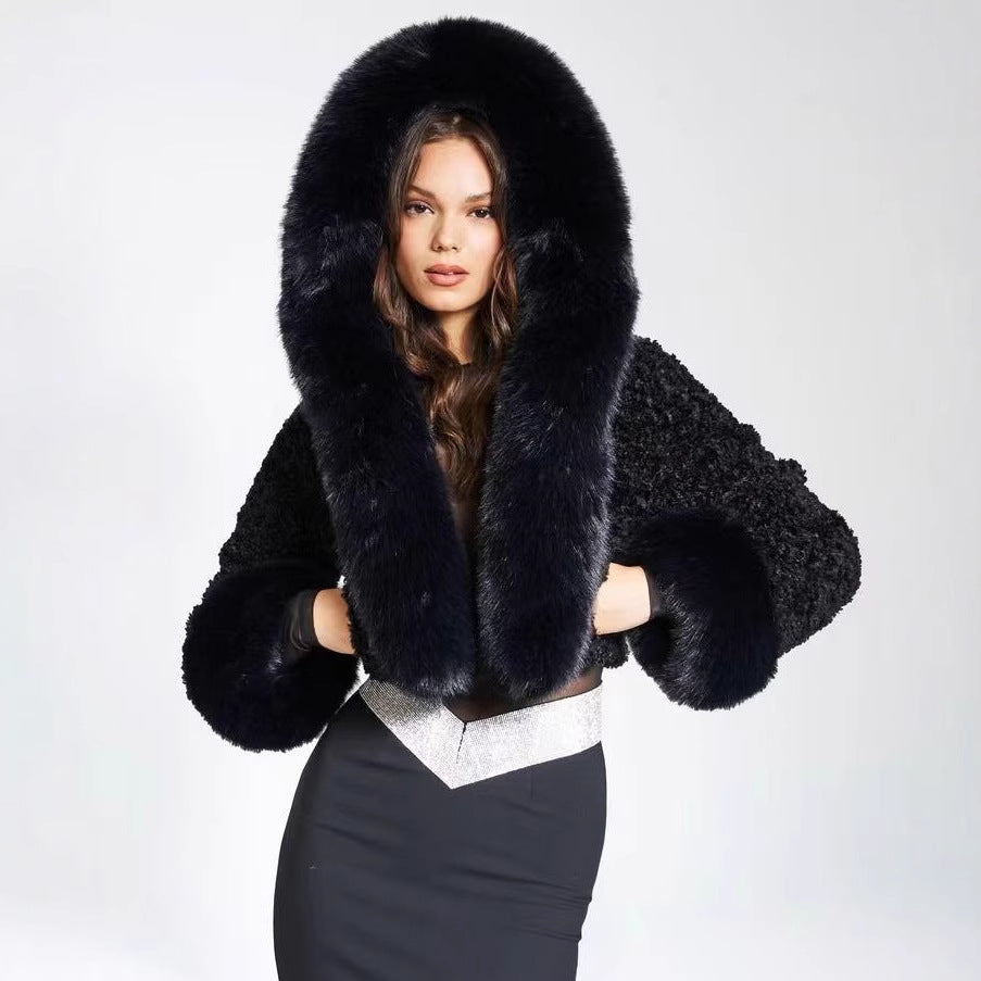 Black faux fur hooded cropped jacket with long pile trim framing the hood on a model