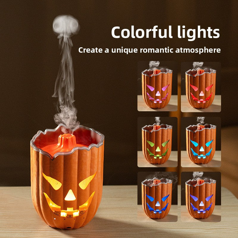 Orange jack o lantern pumpkin diffuser with a carved glowing face and centre mist cone