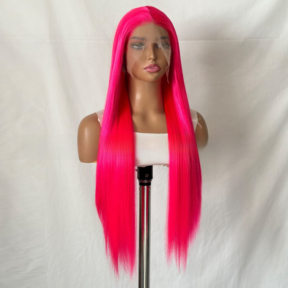 Long straight rose pink synthetic lace front wig on a mannequin head, slightly turned front view