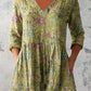 Printed empire peplum tunic top with a bordered print building toward the hem