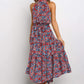 Blue and red boho floral halter neck sleeveless tiered swing maxi dress worn by a model