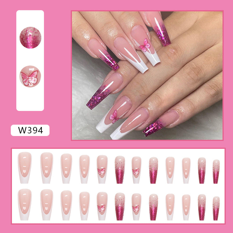 Full cover press-on almond nails in a purple butterfly design, glossy finish shown on a hand