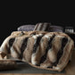Tan with Black Stripes option: tan vegan fur blanket with black stripes on a bed with a tray and cushions