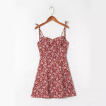 Wine red ditsy floral strap mini dress shown on a wooden hanger