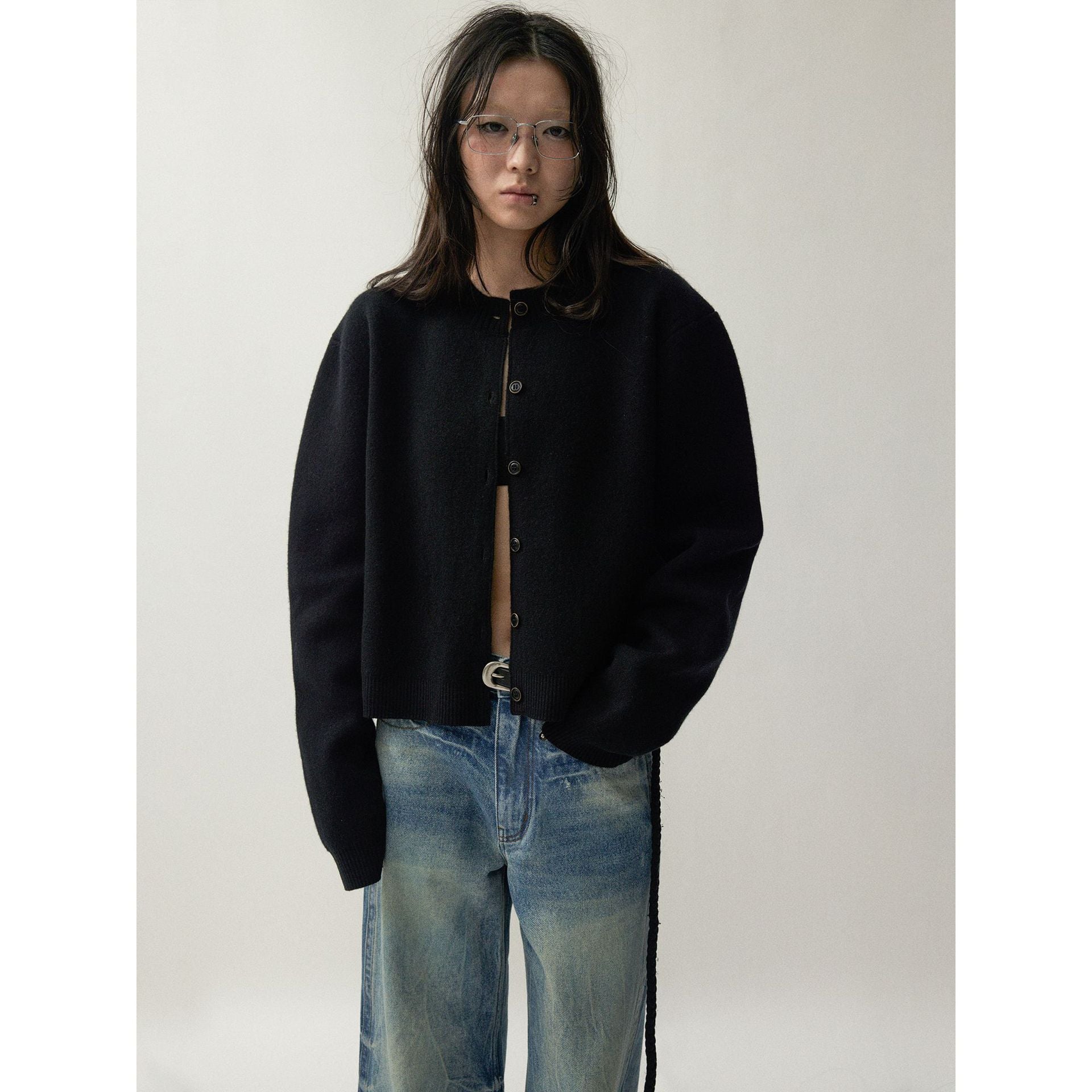 Detail of the front buttons and ribbed placket on the knit cardigan