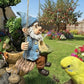 Resin gnome bird feeder hanging in a garden with a budgie perched nearby