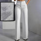 Wide leg trousers styled with a tucked blouse and heels for the office