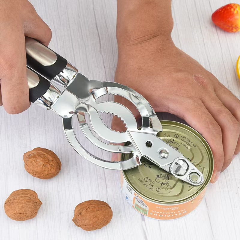 Hand using the stainless multi opener lever tip to open a tin can on a kitchen counter